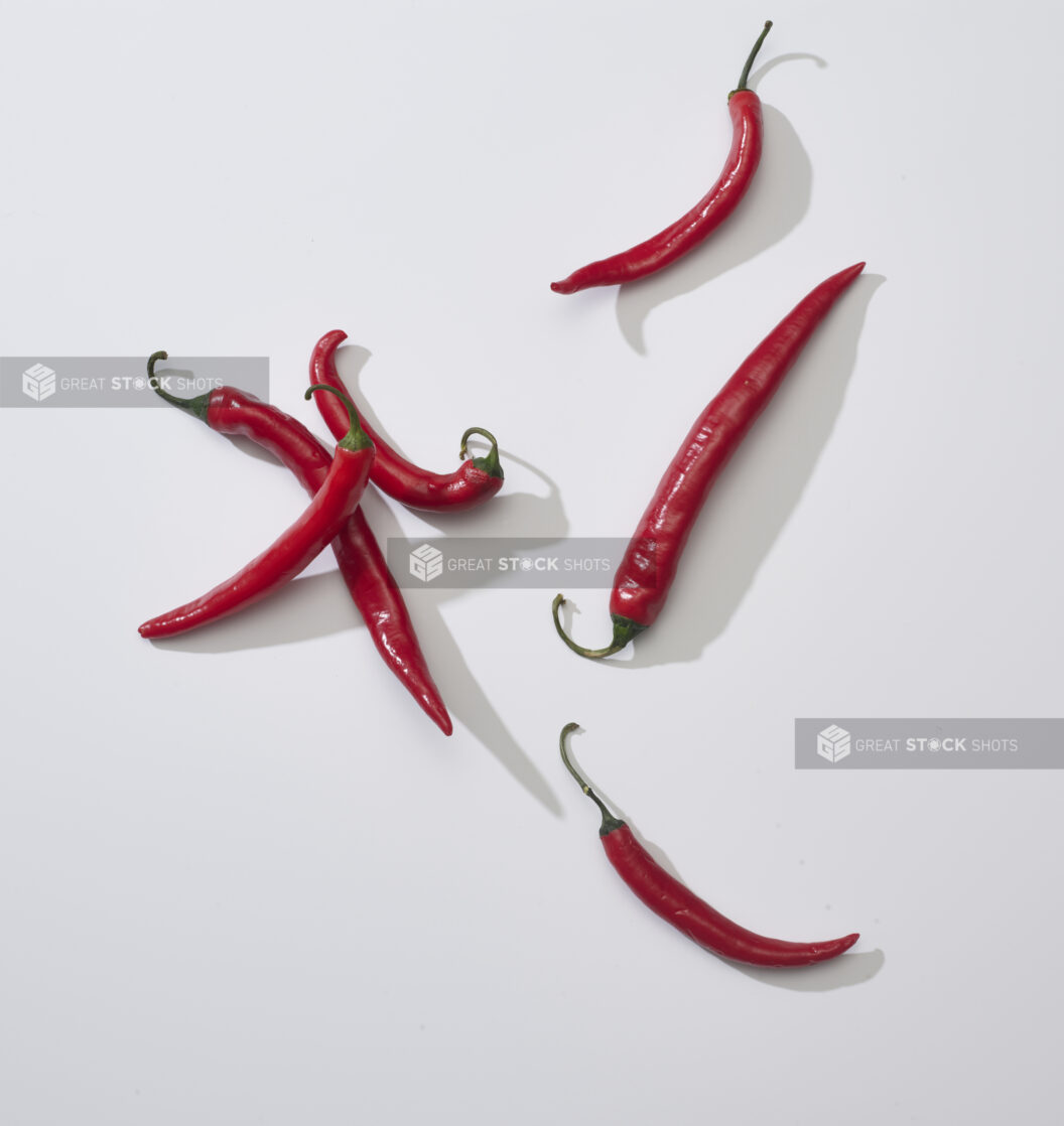 Whole red chili peppers on a white background