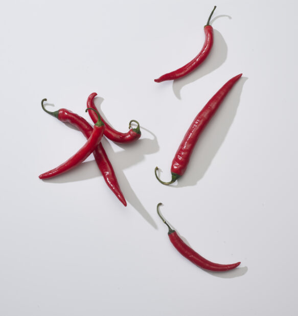 Whole red chili peppers on a white background