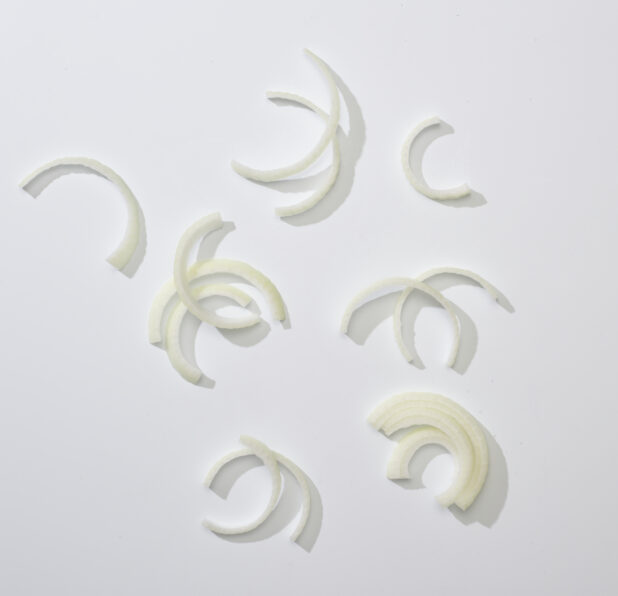 Sliced white onion on a white background