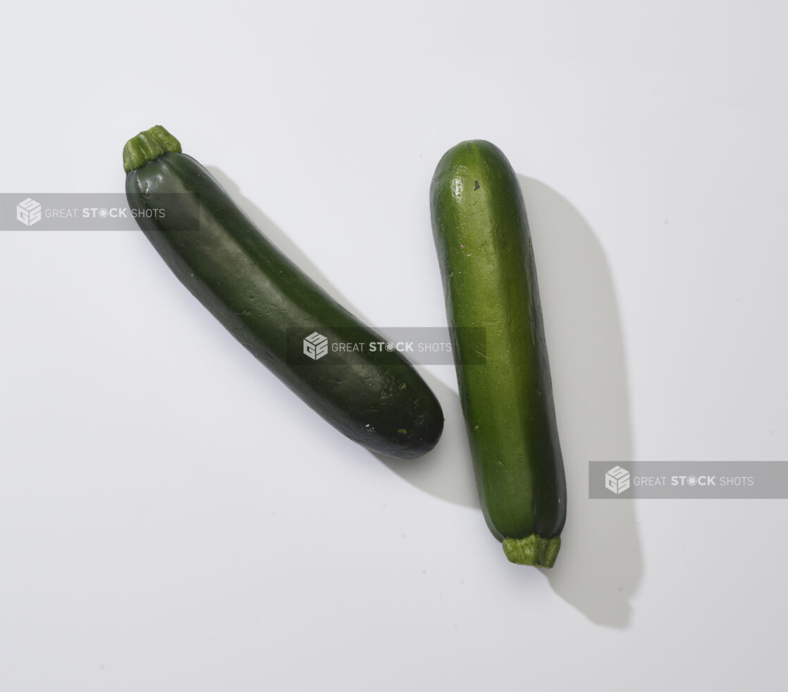 Whole fresh zucchini on a white background