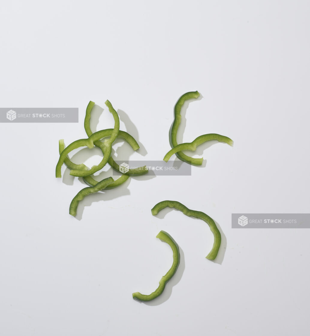 Sliced green Bell pepper on a white background