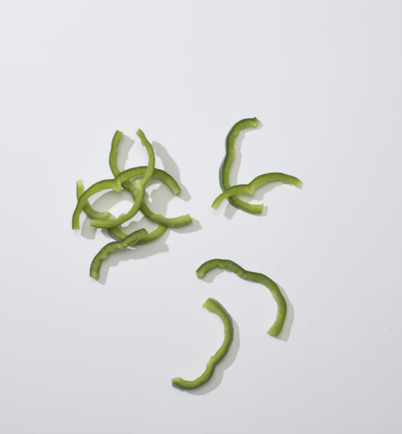 Sliced green Bell pepper on a white background
