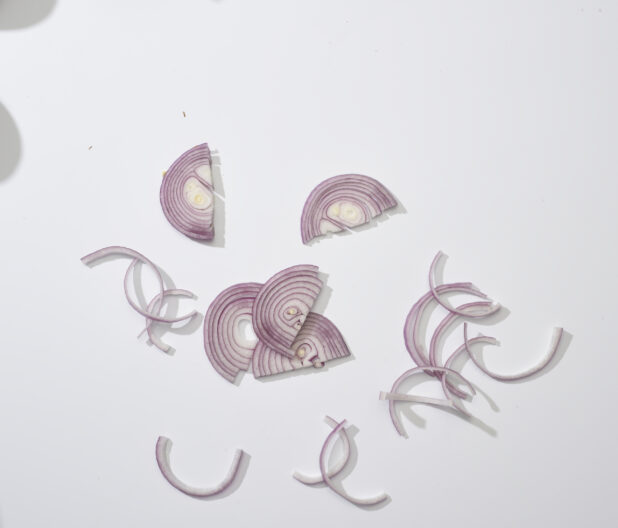 Sliced red onions on a white background