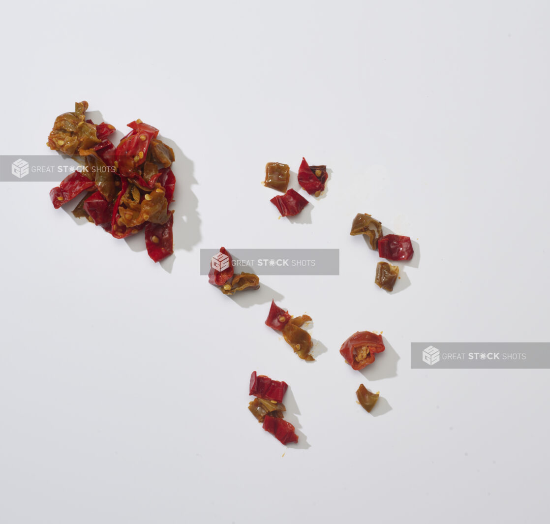 Chopped red chili peppers on a white background