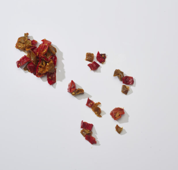 Chopped red chili peppers on a white background