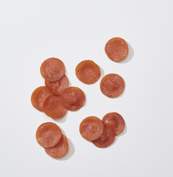 Sliced pepperoni on a white background