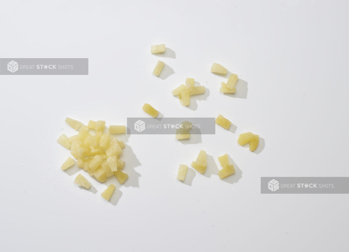 Fresh pineapple chunks on a white background