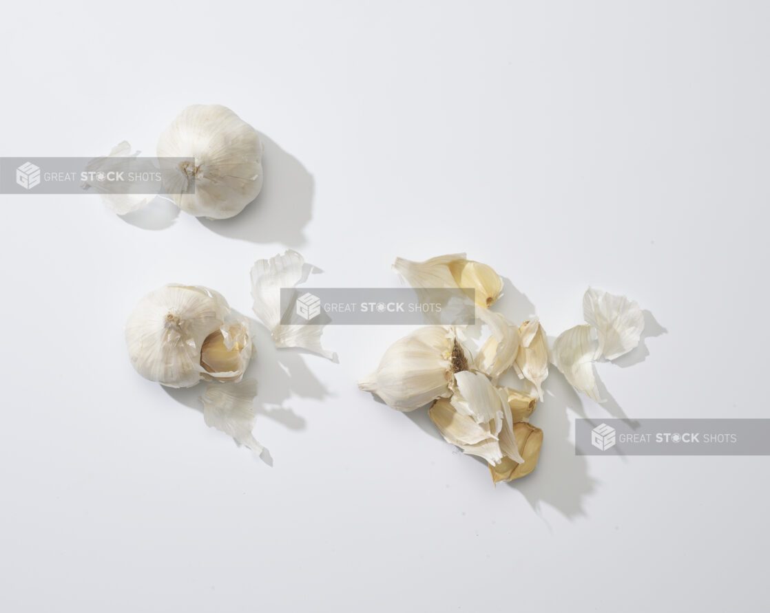 Bulbs and cloves of garlic on a white background