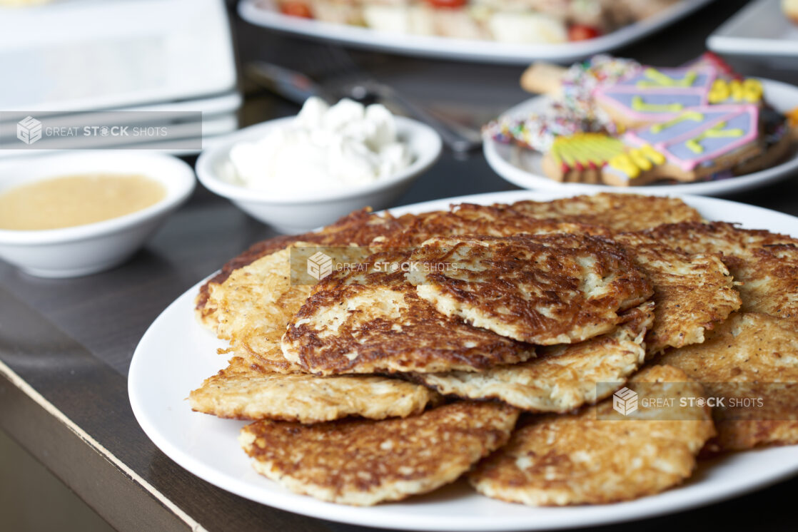 A plate of potato latkes on a buffet of Hanukkah food