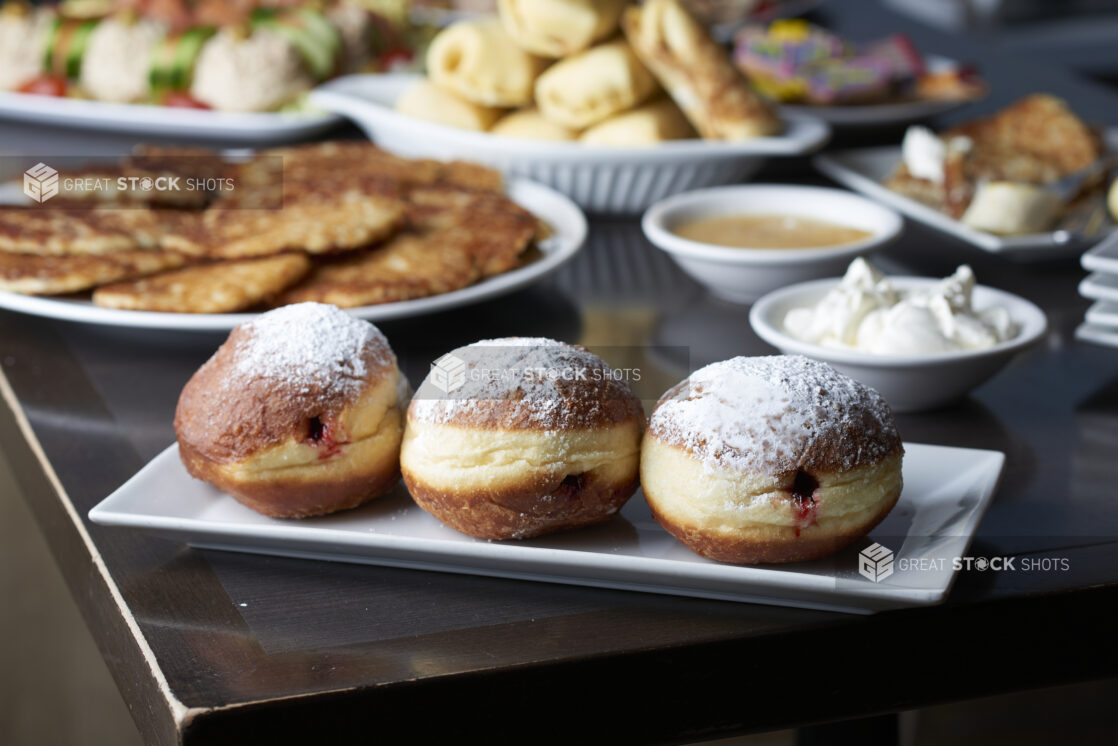 A buffet of assorted plates of Hanukkah food