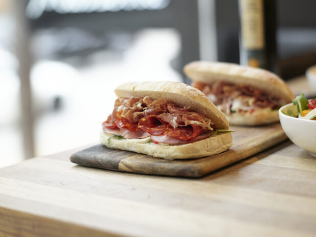 An Italian panini sandwich with prosciutto, Genoa salami, and ham