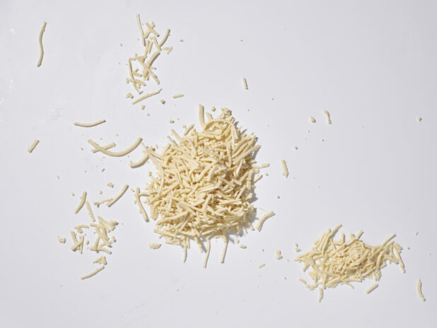 Shredded mozzarella on a white background