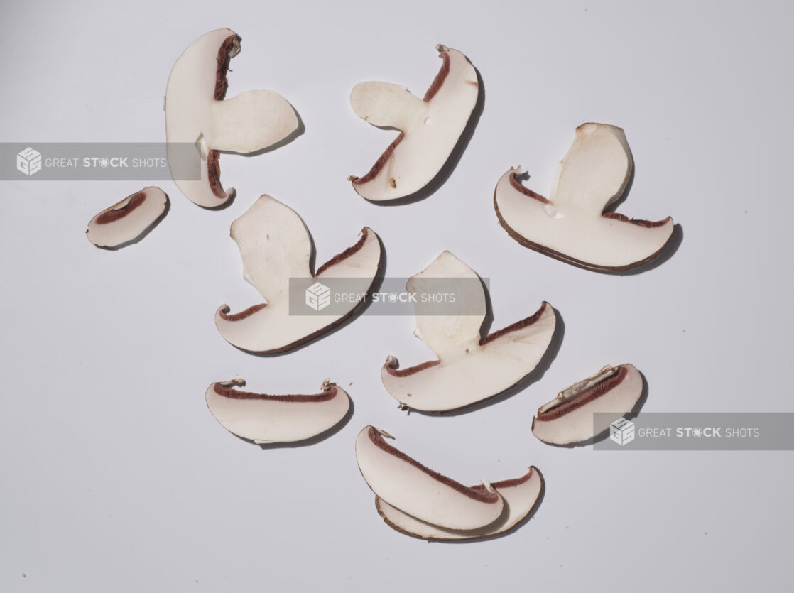 Thinly sliced mushrooms on a white background