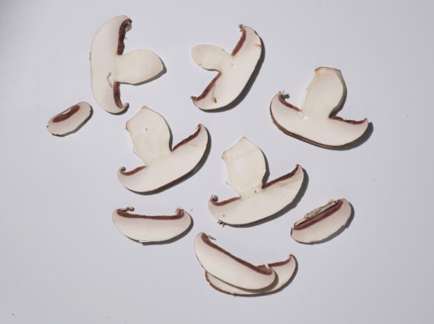 Thinly sliced mushrooms on a white background