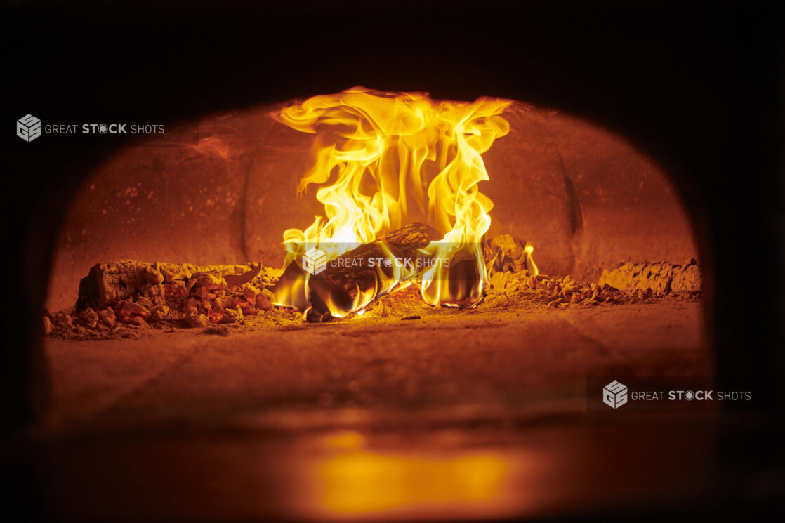 Mesmerizing middle eastern wood burning oven with logs on fire, close up view