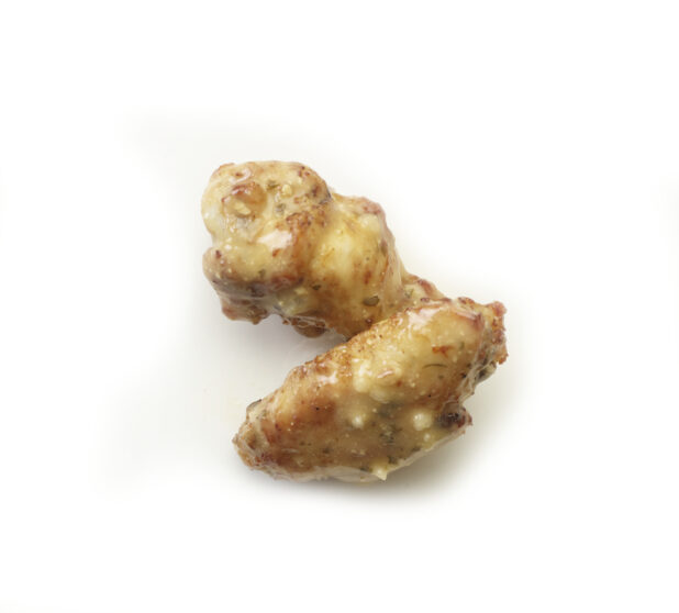 Garlic parmesan sauced wings on a white background