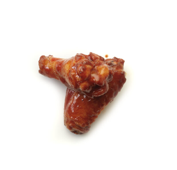 Tandoori sauced wings on a white background