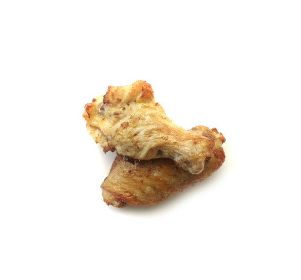 Oven roasted sauced wings on a white background