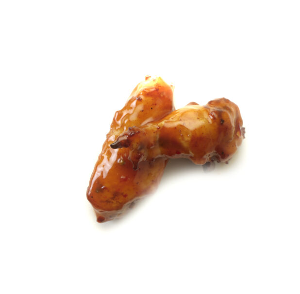 Mango habanero sauced wings on a white background
