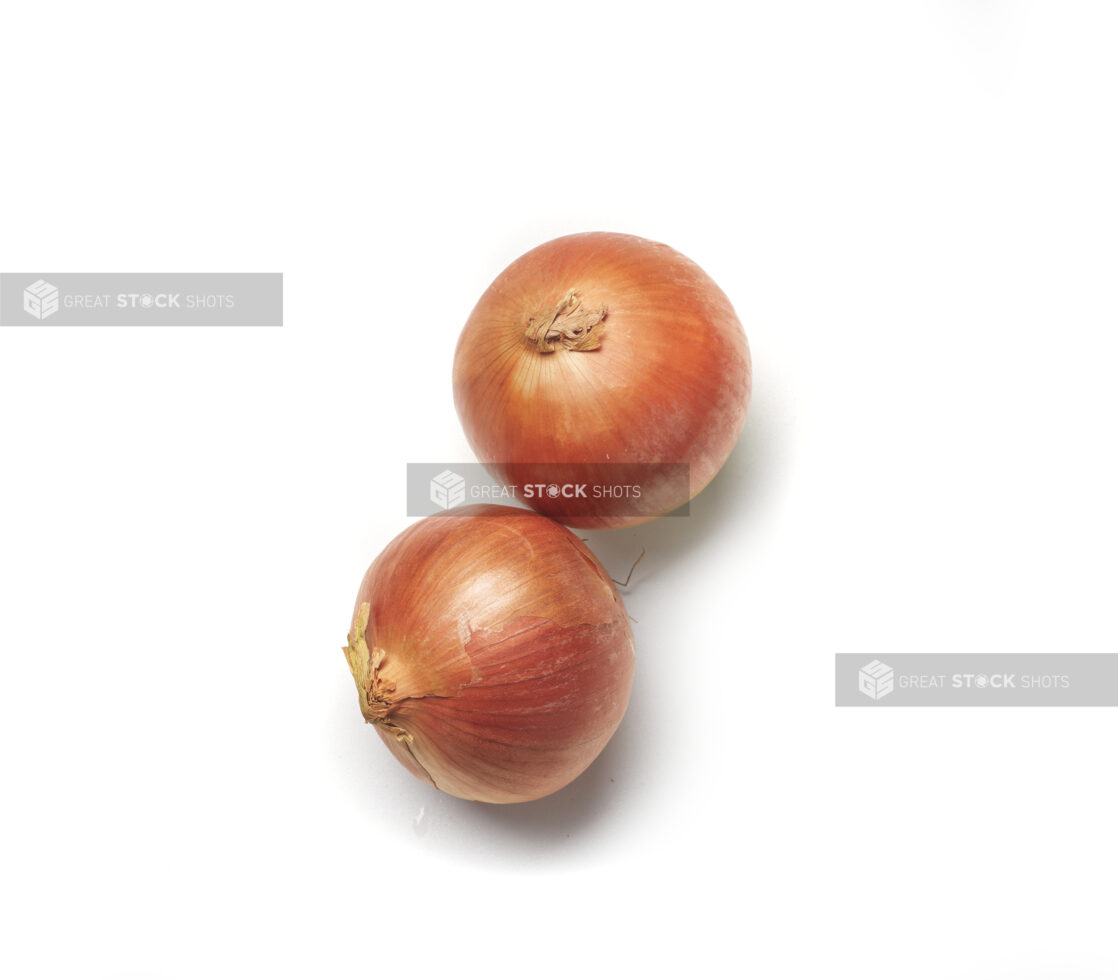 Whole cooking onions on a white background