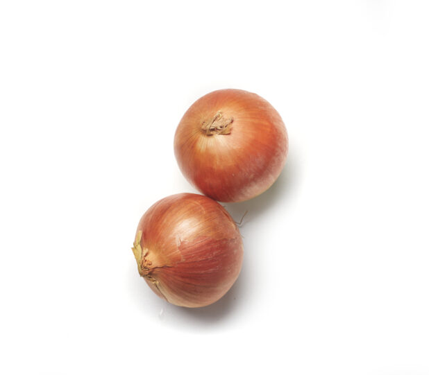Whole cooking onions on a white background