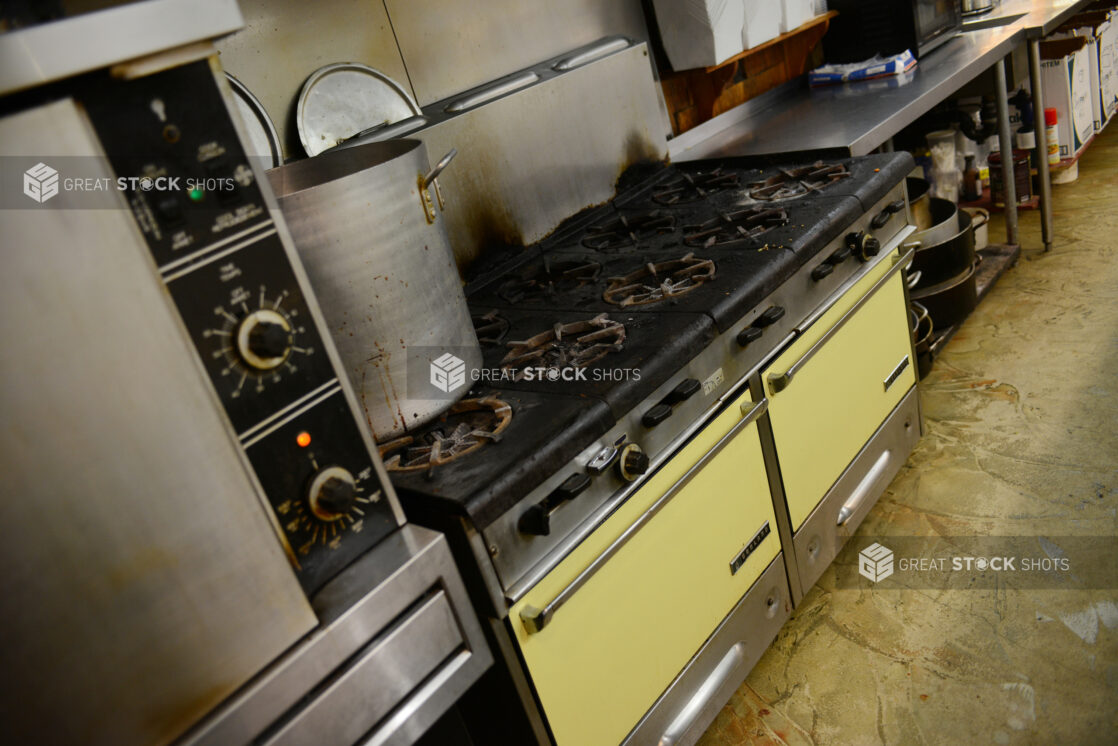 Commercial/restaurant kitchen, view of gas range, ovens, prep table