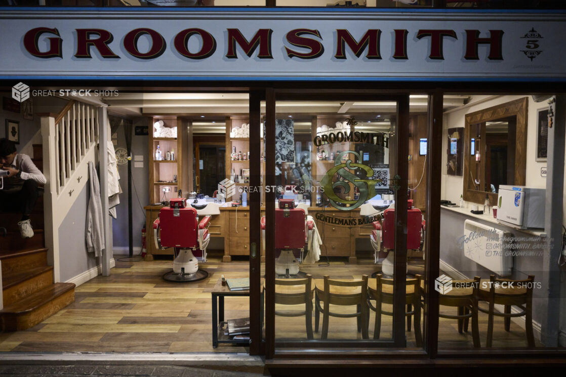 Looking into a gentleman's barber shop from the street in London, England,