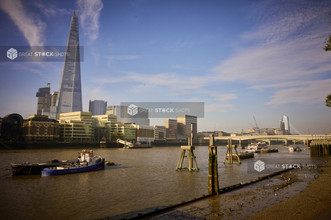 Wide shot of the Thames River in London with The Shard Building in background