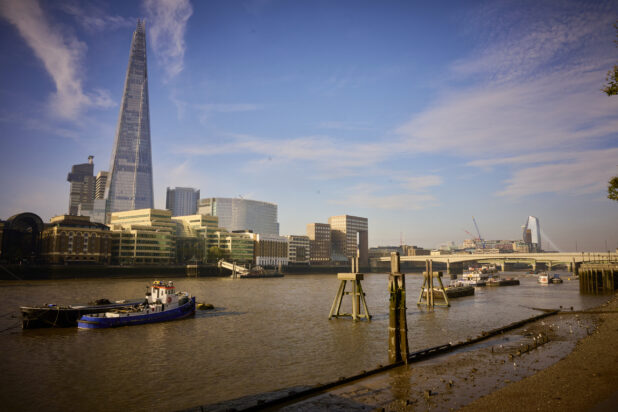 Wide shot of the Thames River in London with The Shard Building in background