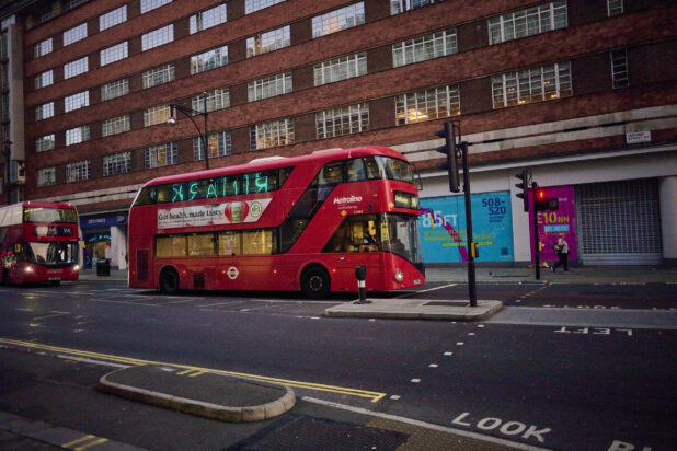 2 double decker buses on a street in London, England