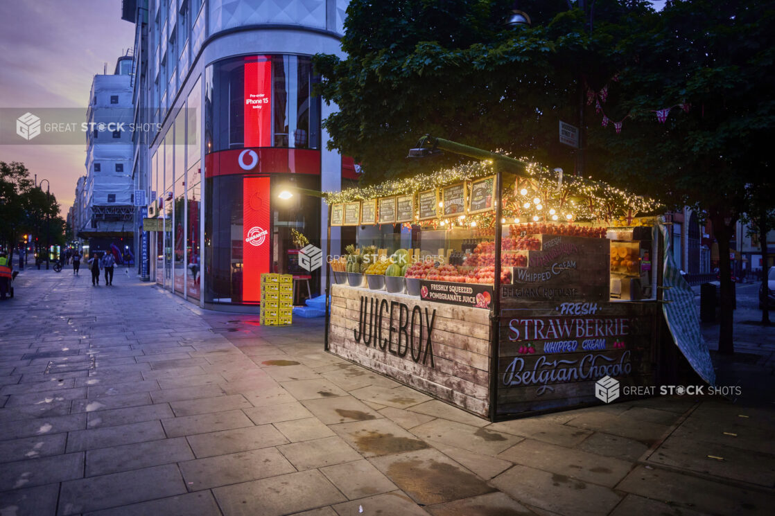 Outdoor juice bar with fresh fruits and vegetables on side of the street, vibrant colours