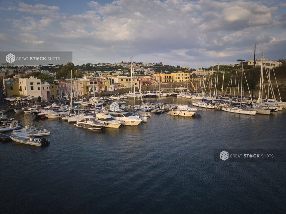 View of a marina with a town and hillside in Italy