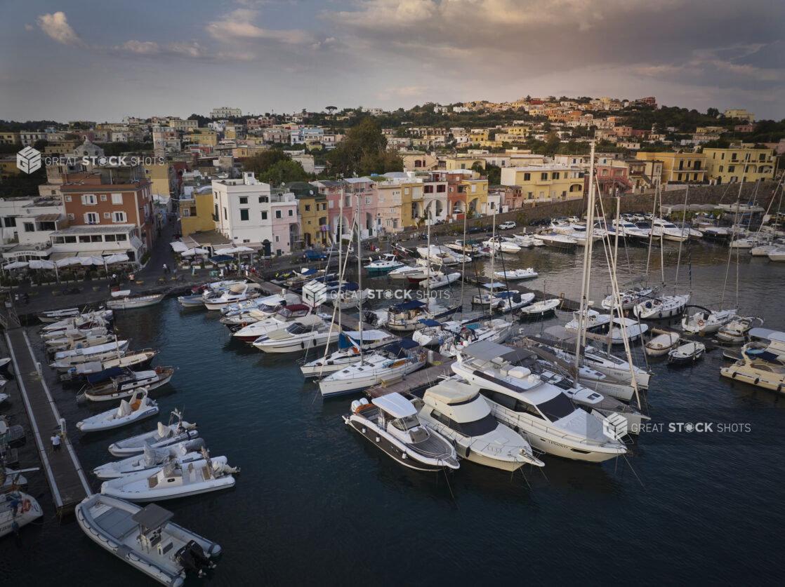 View of a marina in Italy, colourful homes, hillside