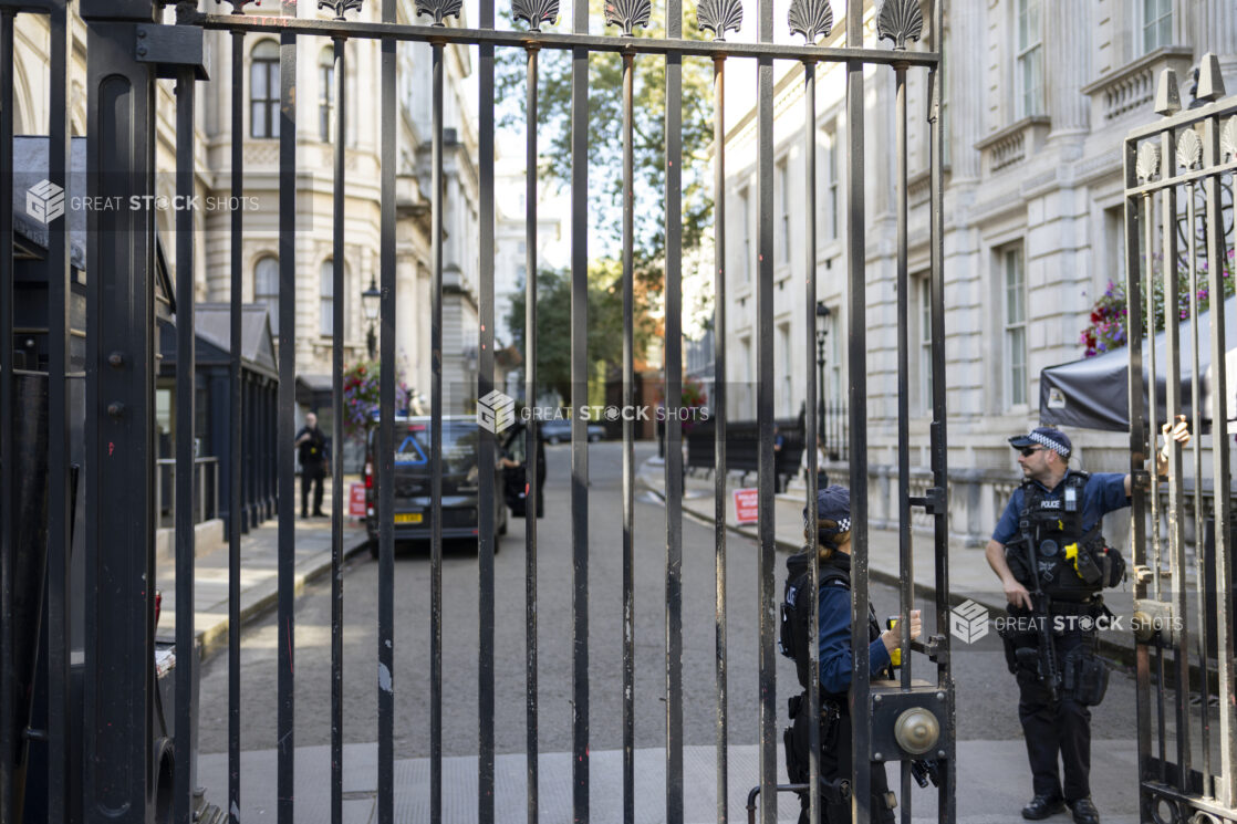 London Police standing by a wrought iron gate at 10 Downing street