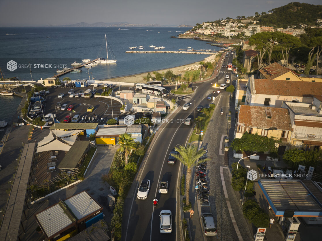 Sunset/sunrise view of an Italian coastal town with a marina, homes and hillside