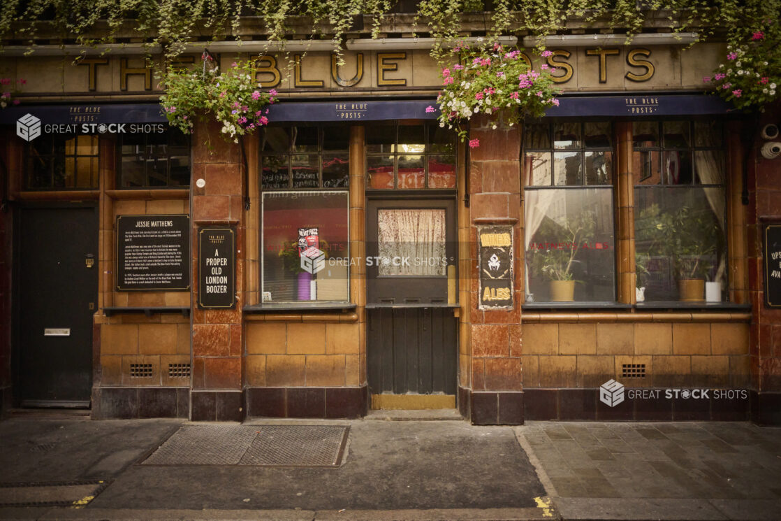 London, England pub exterior, street view, hanging plants, "A Proper old London boozer"