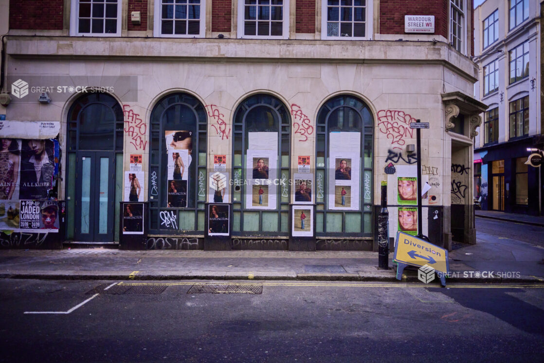 Exterior view of a building with graffiti on a street corner, London, England, UK