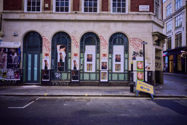 Exterior view of a building with graffiti on a street corner, London, England, UK