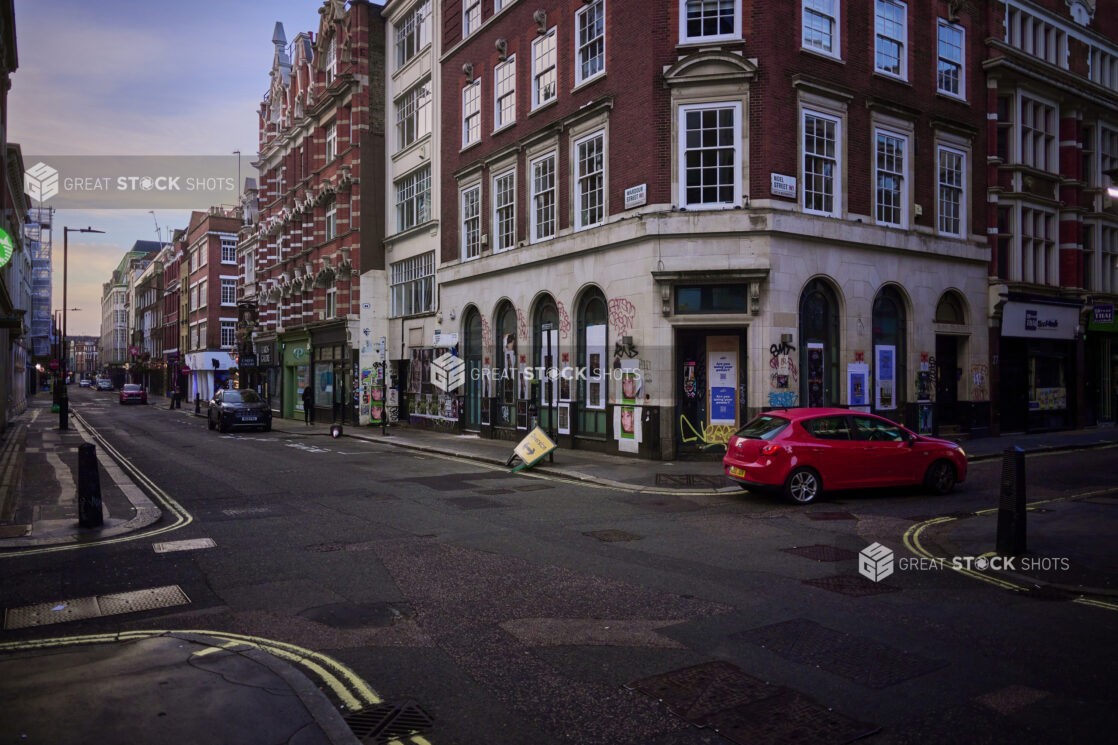 Street view of a London, England street with buildings, cars, graffiti on buildings