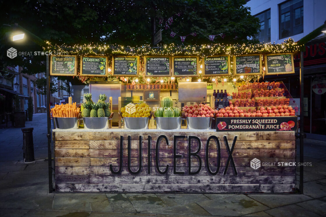 Straight on view of an outdoor juice stand with fresh fruits and vegetables, vibrant colours,