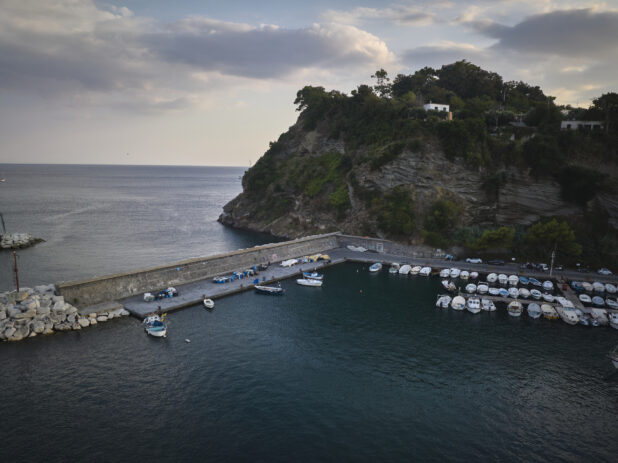View of a marina in Italy with a hillside in the background