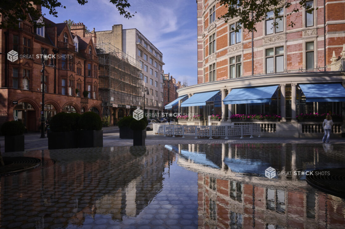 Wide shot of buildings in London England, with reflection of buildings in fountain water