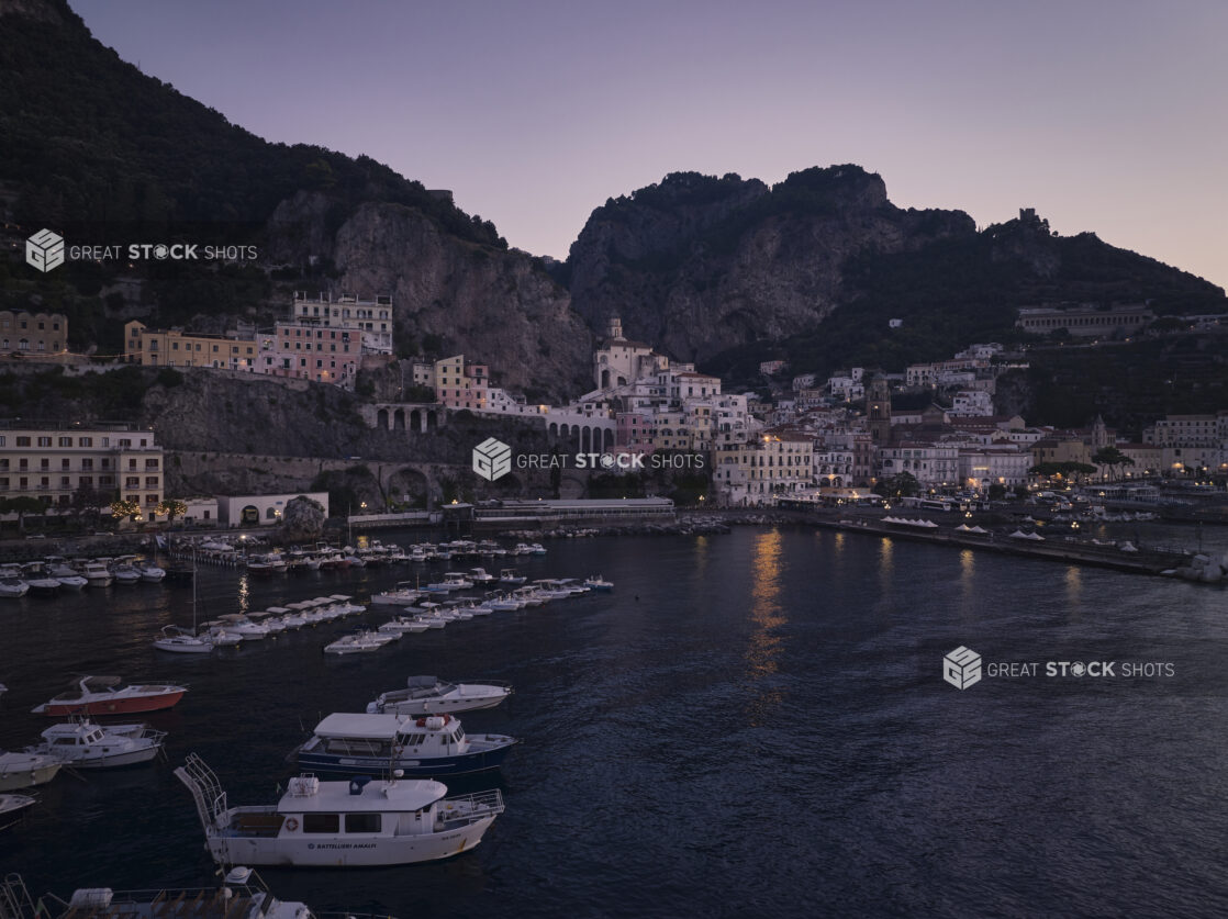 Sunrise/sunset view of an Italian coastal town, shoreline and marina