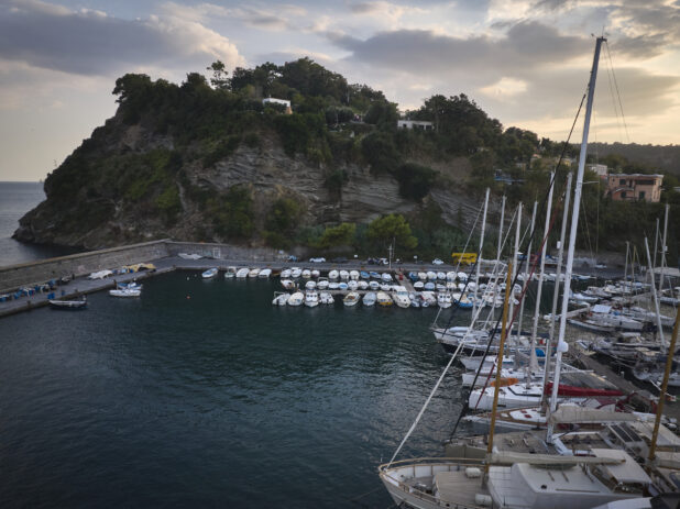 View of a marina in Italy with a hillside in the background