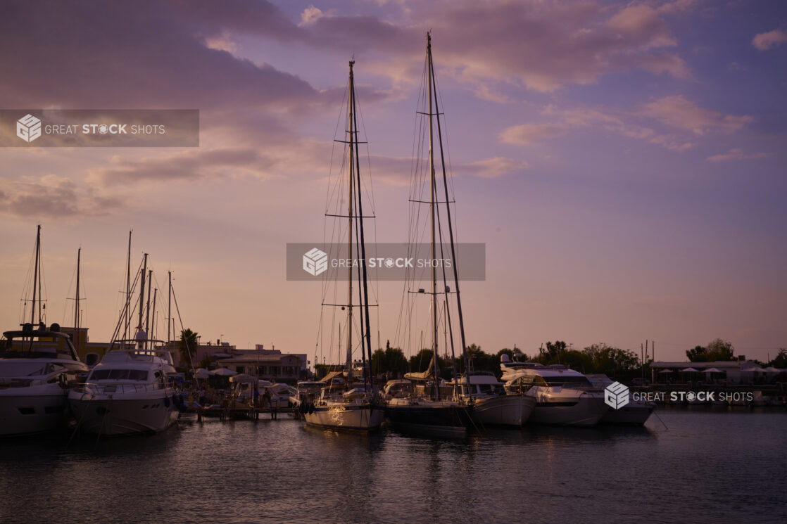 Yachts, Boats and Sailboats Docked in Marina at Sunset