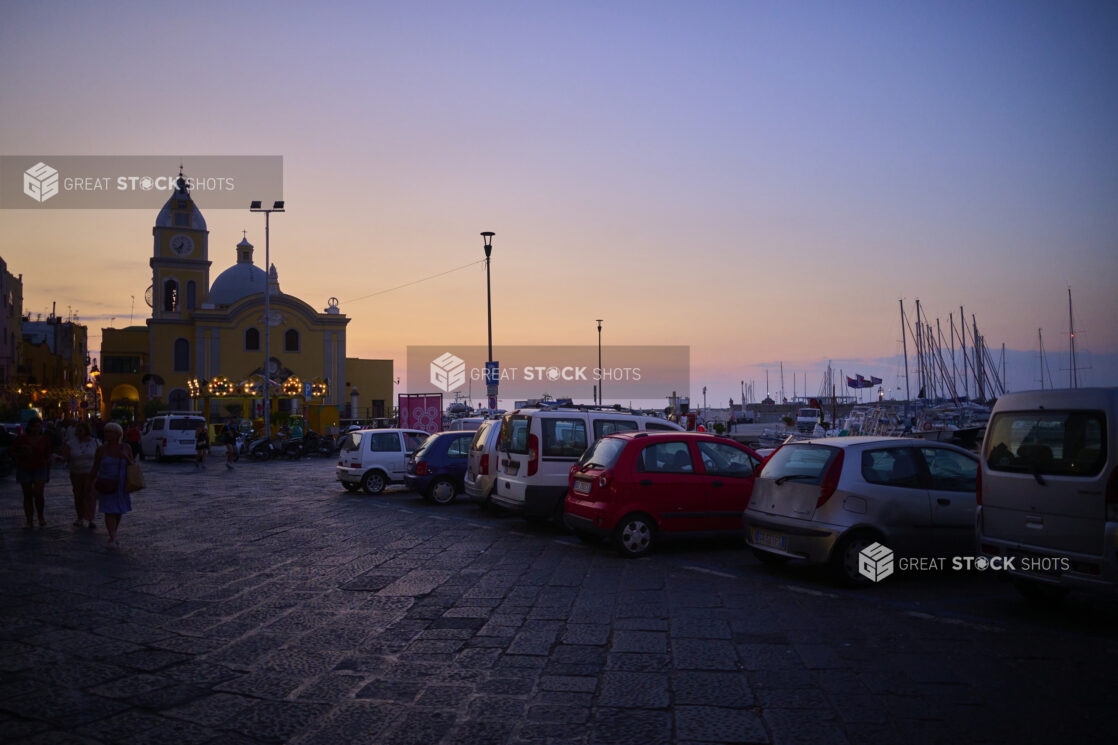 Parking lot of Italian Coast Harbour or Marina at Sunset with a building in the background