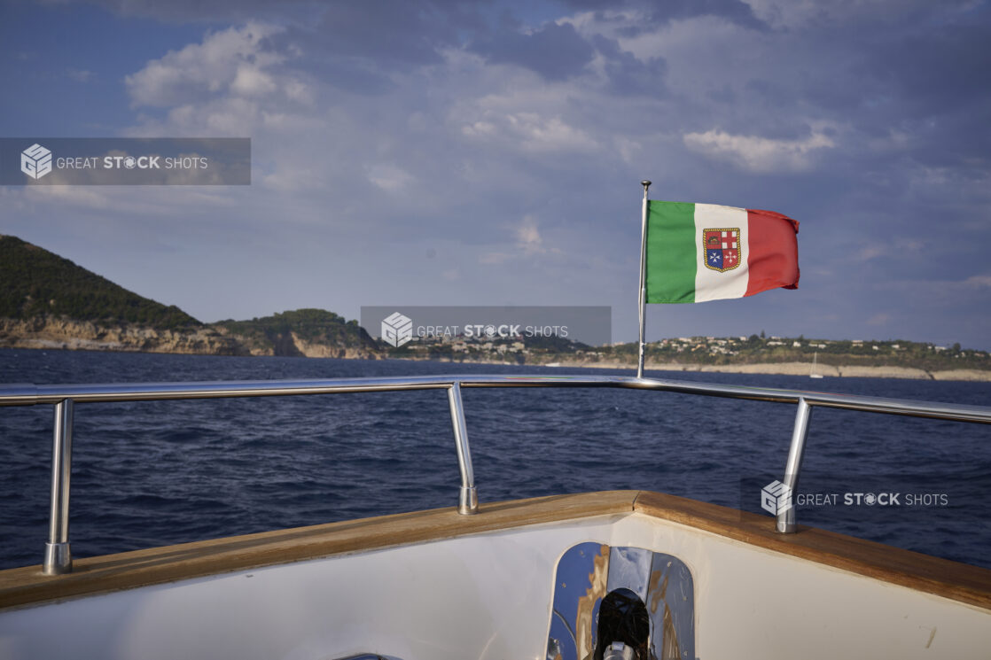 Yacht with Italian Flag Cruising along Coastline