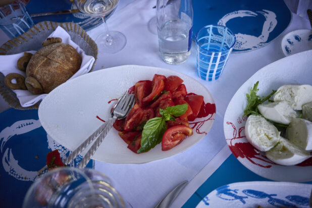 Overhead view of a Mediterranean style meal with seafood patterned dishes