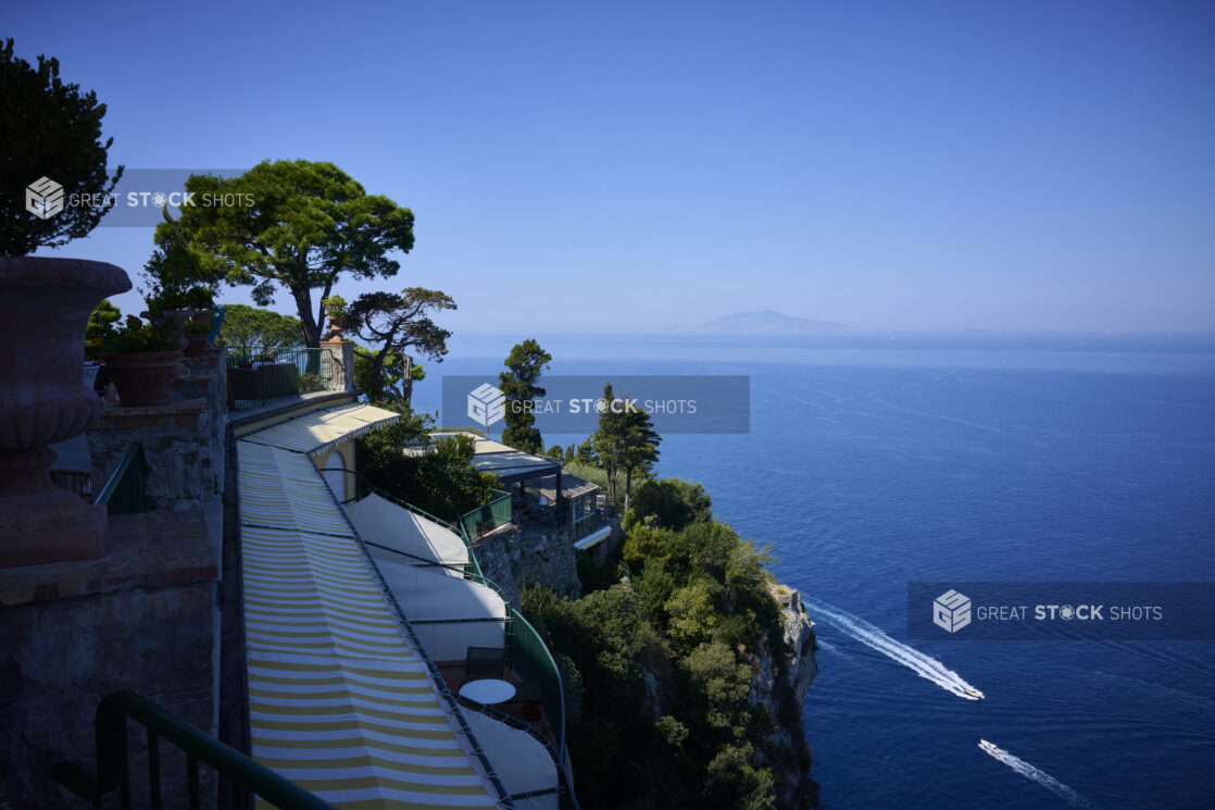 Ocean View from Mountain Resort Restaurant on a Cliff, overlooking the water with Lush Green Trees and Bushes in Capri, Italy