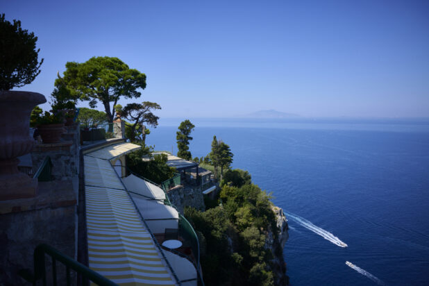 Ocean View from Mountain Resort Restaurant on a Cliff, overlooking the water with Lush Green Trees and Bushes in Capri, Italy